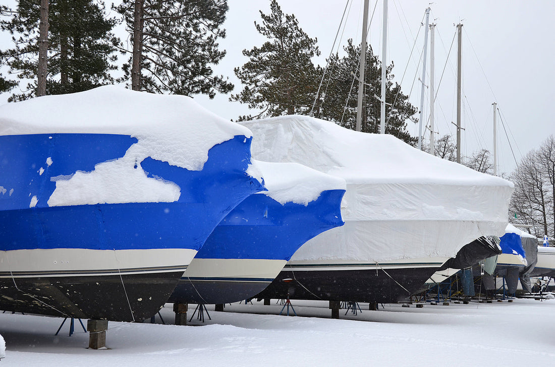boats surrounded and covered by snow