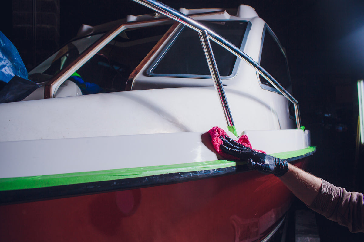 Person cleaning boat at night
